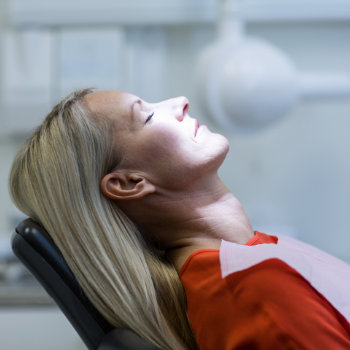 Woman relaxing on dentist chair Duluth Dental Studio care